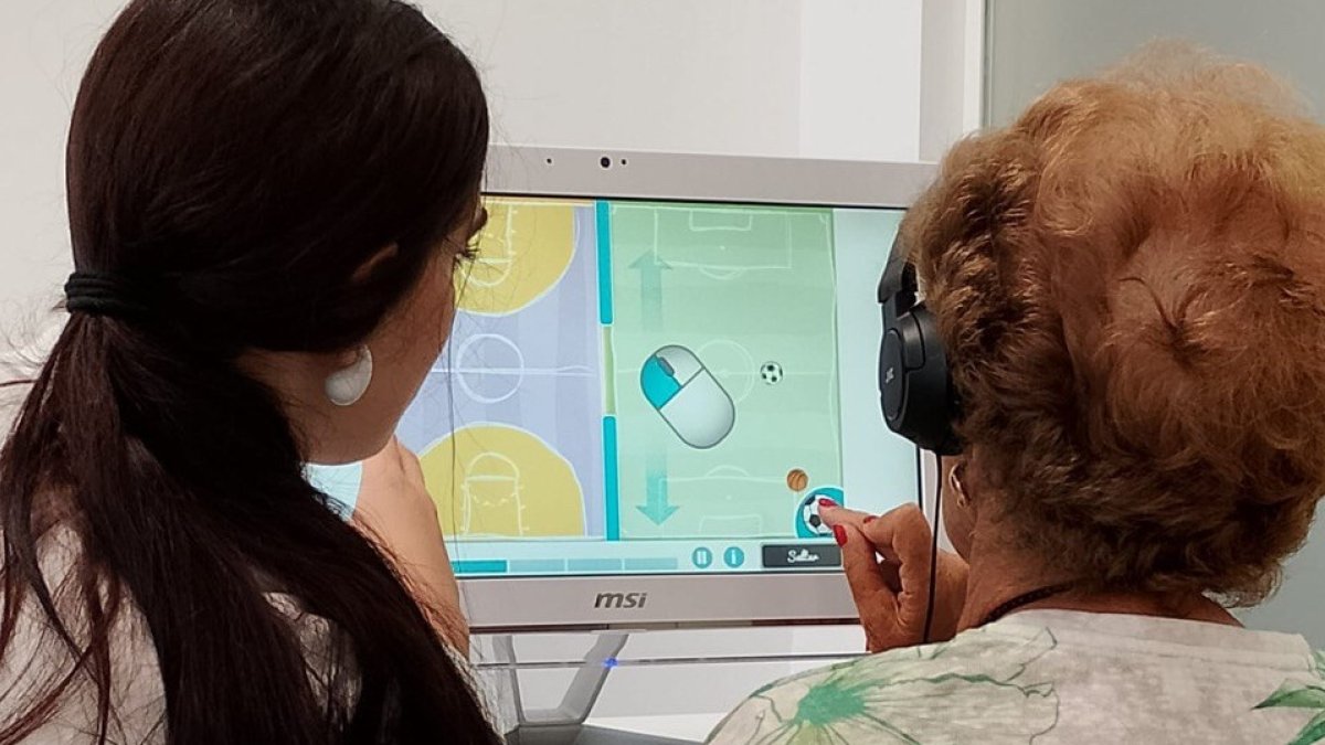 Psicóloga acompañando a una paciente durante una sesión de rehabilitación motora.