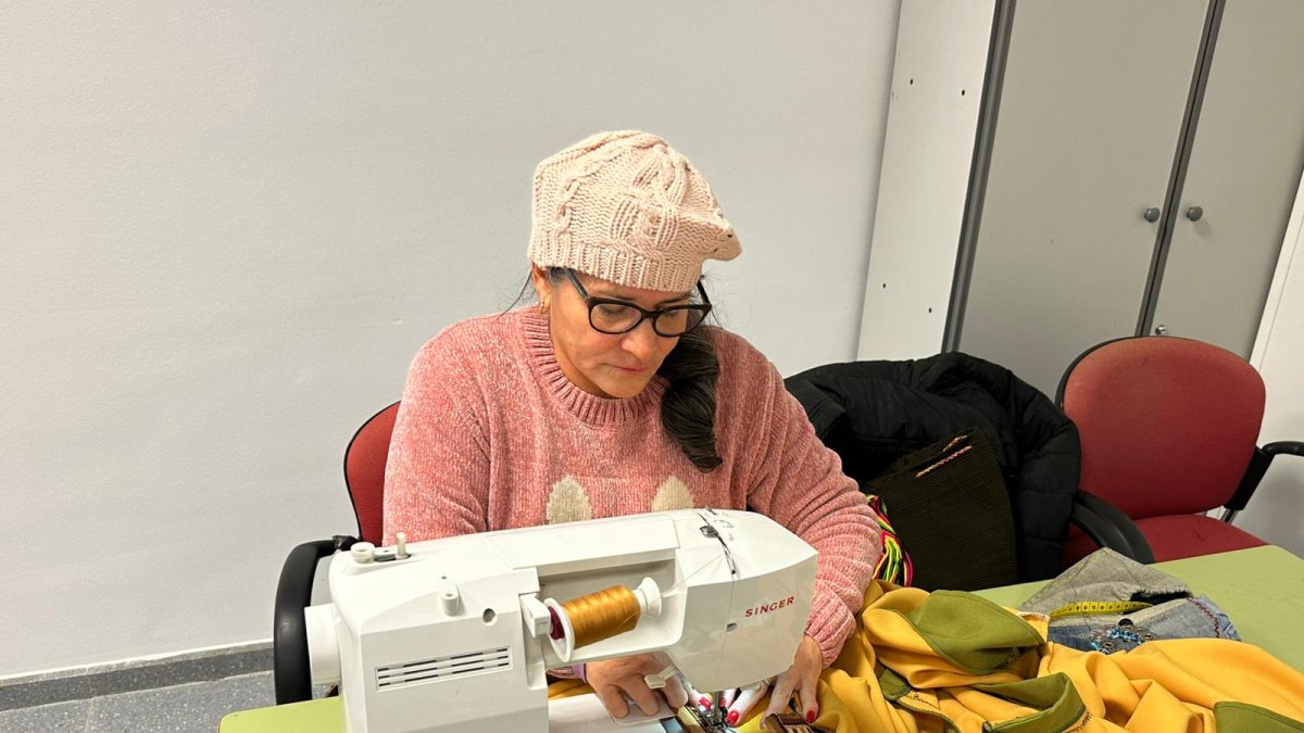 Una alumna cosiendo una de las túnicas del Belén Viviente de Las Norias.