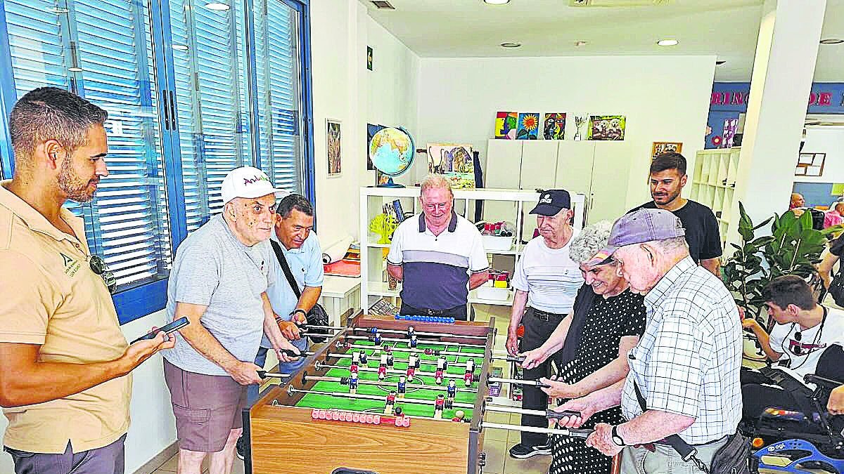 Residentes jugando al futbolín en el Centro de mayores de El Zapillo en Almería.