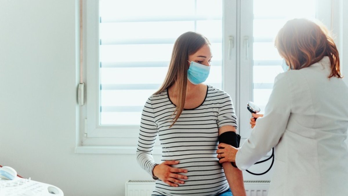 Una médica atiende a una paciente embarazada.