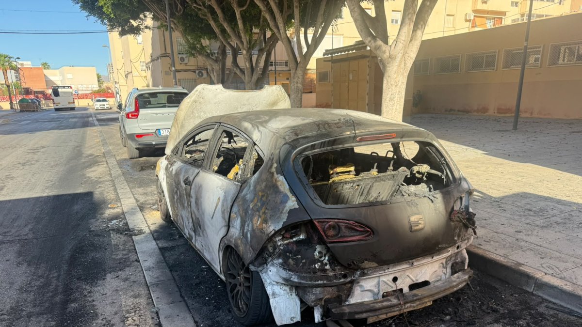 Coche calcinado en la calle Darrícal de Las 500 Viviendas de Almería capital.