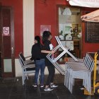 Trabajadores recogiendo las mesas de un establecimiento hostelero