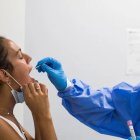 Toma de muestras a una mujer para una prueba PCR.