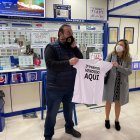 El lotero de la administración que ha repartido la suerte celebra el premio.