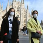 Dos jóvenes italianas con mascarilla en Milán.
