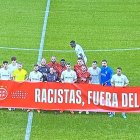 Los dos equipos posan contra el racismo.