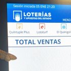 La palomica de la suerte reposada sobre las pantallas de la Administración de Loterías nº15.