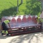 Los trabajadores descargando los banquillos en el Estadio.