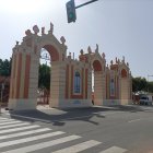 Un operario repinta la portada de la feria de la noche