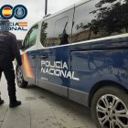 Agente de la Policía Nacional junto a un furgón.