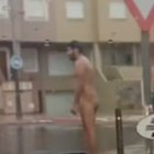 Un hombre se pasea desnudo bajo la lluvia en Roquetas de Mar.