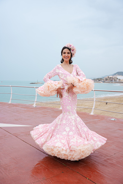 Una modelo posa con un diseño de inspiración flamenca en tonos pastel, una de las propuestas más delicadas de Islu Creaciones.